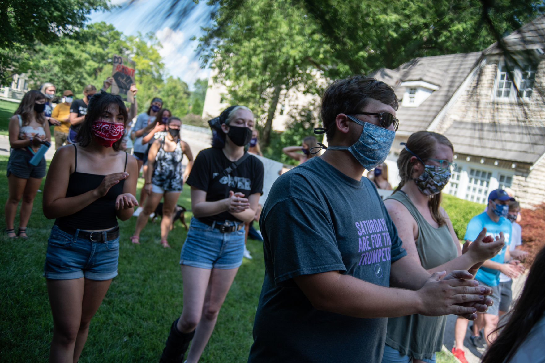 Peaceful protestors clap after listening to Kirsten Novotny read a letter from George FloydÕs niece on Saturday.